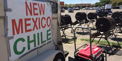 FILE - This Aug. 11, 2016 file photo shows Green chile from Hatch, N. M., on sale, at a roadside roasting stand in Santa Fe, N.M. New Mexico farmers produced fewer of the state's famed hot peppers in 2017, and data released Tuesday, March 13, 2018 by federal and state agriculture officials show the value of the chile crop has declined. (AP Photo/Morgan Lee,File)