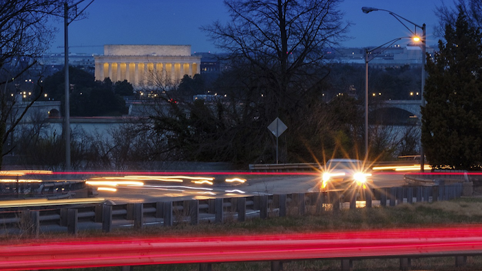 Traffic streaks along U.S. Highway 50 early in the morning, Friday, March 30, 2018 across the Potomac River from Washington in Arlingotn, Va. Image credit: AP Photo/J. David Ake