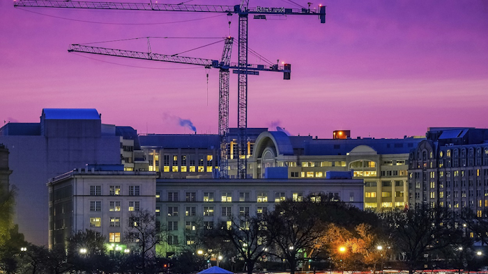 In this Tuesday, March 27, 2018, photo, construction cranes in Southwest Washington are silhouetted against the morning sky as redevelopment continues in the waterfront area of the District of Columbia. Image credit: AP Photo/J. David Ake