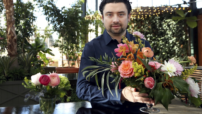 In this March 23, 2018, photo, Shane Pliska, owner of Planterra, a commercial florist and owner of a wedding venue where the decor is all about flowers and plants poses for a photo at his company, in West Bloomfield, Mich. Image credit: AP Photo/Carlos Osorio