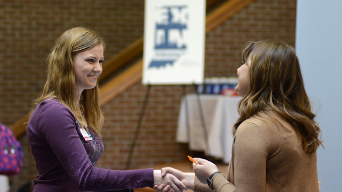 In this March 14, 2018, file photo, Indiana Wesleyan University senior Courtney Kingma, left, thanks Jennie Hehe, community resource manager for Tangram, for talking with her during the Experience Indiana job fair event in the student center at IWU in Marion, Ind. Image credit: (Jeff Morehead/The Chronicle-Tribune via AP, File
