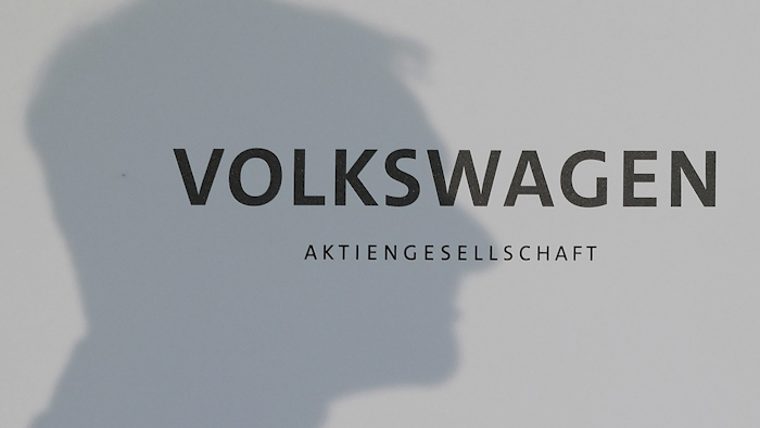In this Aug. 29, 2016 file photo the shadow of Volkswagen CEO Matthias Mueller is seen in Hamburg, Germany. Image credit: Axel Heimken/dpa via AP, file