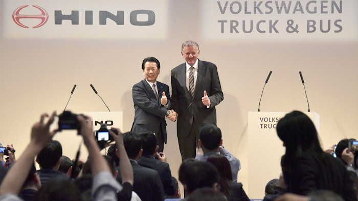 Andreas Renschler, right, a board member at Volkswagen AG and CEO of Volkswagen Truck & Bus, and Hino Motors President and Chief Executive Yoshio Shimo, left, pose for the media during a press conference in Tokyo, Thursday, April 12, 2018. Image credit: Katsuya Miyagawa/Kyodo News via AP