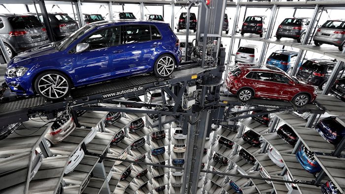 In this March 14, 2017 file photo Volkswagen cars are lifted inside a delivery tower of the company in Wolfsburg, Germany. Image credit: AP Photo/Michael Sohn, file