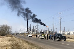This photo provided by KQDS_FOX21 in Duluth, Minn., shows vehicles and personnel outside the Husky Energy oil refinery Thursday morning, April 26, 2018, after a tank containing crude oil or asphalt exploded at the large refinery in Superior, Wis. Image credit: Natalie Froistad/KQDS_FOX21 via AP