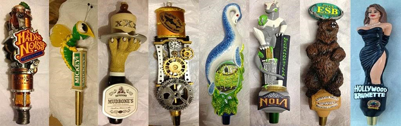 Figure 1: An arrangement of custom tap handles created for craft breweries. Image from Custom Beer Handles’s article, “The 5 Best Custom Craft Beer Tap Handles,” available at custombeerhandles.com.