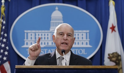 Gov. Jerry Brown discusses a lawsuit filed by 17 states and the District of Columbia over the Trump administration's plans to scrap vehicle emission standards during a news conference Tuesday, May 1, 2018, in Sacramento, Calif. Image credit: AP Photo/Rich Pedroncelli