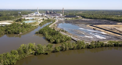 The Richmond city skyline can be seen on the horizon behind the coal ash ponds along the James River near Dominion Energy's Chesterfield Power Station in Chester, Va., Tuesday, May 1, 2018. Image credit: AP Photo/Steve Helber