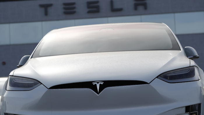 In this April 15, 2018, file photo, an unsold 2018 Model X 100d sits on a Tesla dealer's lot in the south Denver suburb of Littleton, Colo. Image credit: AP Photo/David Zalubowski, File