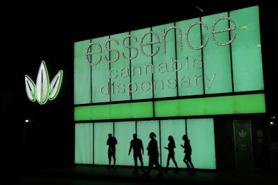 In this April 16, 2018, photo, people stand outside after shopping at the Essence cannabis dispensary in Las Vegas. Image credit: AP Photo/John Locher