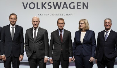 Herbert Diess, center , CEO of the Volkswagen stock company, and the members of the Board of Management of Volkswagen, Hiltrud Dorothea Werner, 2nd right, and Frank Witter, 2nd left, Oliver Blume, left, CEO of Porsche AG, and Rupert Stadler, right, CEO of Audi AG, pose for the media prior to the shareholder's meeting in Berlin, Germany, Thursday, May 3, 2018. Image credit: AP Photo/Michael Sohn