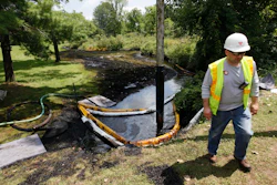 In this July 29, 2010, file photo, a worker monitors the water in Talmadge Creek in Marshall Township, Mich., near the Kalamazoo River as oil from a ruptured pipeline, owned by Enbridge Inc, is vacuumed out of the water.Image credit: AP Photo/Paul Sancya, File