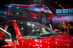 In this April 25, 2018, file photo, attendees look at the Tang SUV by Chinese automaker BYD after a press conference at the China Auto Show in Beijing. Image credit: AP Photo/Mark Schiefelbein, File