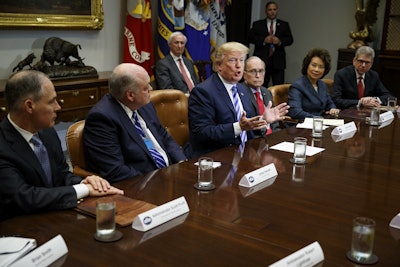 President Donald Trump speaks during a meeting with automotive executives in the Roosevelt Room of the White House, Friday, May 11, 2018, in Washington. From left, Environmental Protection Agency administrator Scott Pruitt, Ford CEO James Hackett, Trump, White House chief economic adviser Larry Kudlow, Secretary of Transportation Elaine Chao, and Nissan Motor Company senior vice president Scott Becker. Image credit: AP Photo/Evan Vucci