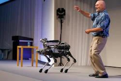 In this July 20, 2017 file photo, Boston Dynamics Chief Executive Marc Raibert speaks about his four-legged robot SpotMini during a SoftBank World presentation at a hotel in Tokyo. Image credit: AP Photo/Shizuo Kambayashi, File