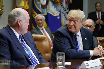 Ford CEO James Hackett talks to President Donald Trump during a meeting with automotive executives in the Roosevelt Room of the White House, Friday, May 11, 2018, in Washington. Image credit: AP Photo/Evan Vucci