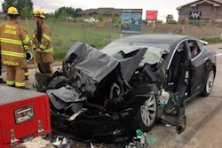 In this Friday, May 11, 2018, photo released by the South Jordan Police Department shows a traffic collision involving a Tesla Model S sedan with a Fire Department mechanic truck stopped at a red light in South Jordan, Utah. Image credit: South Jordan Police Department via AP