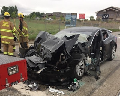 In this Friday, May 11, 2018, photo released by the South Jordan Police Department shows a traffic collision involving a Tesla Model S sedan with a Fire Department mechanic truck stopped at a red light in South Jordan, Utah. Image credit: South Jordan Police Department via AP