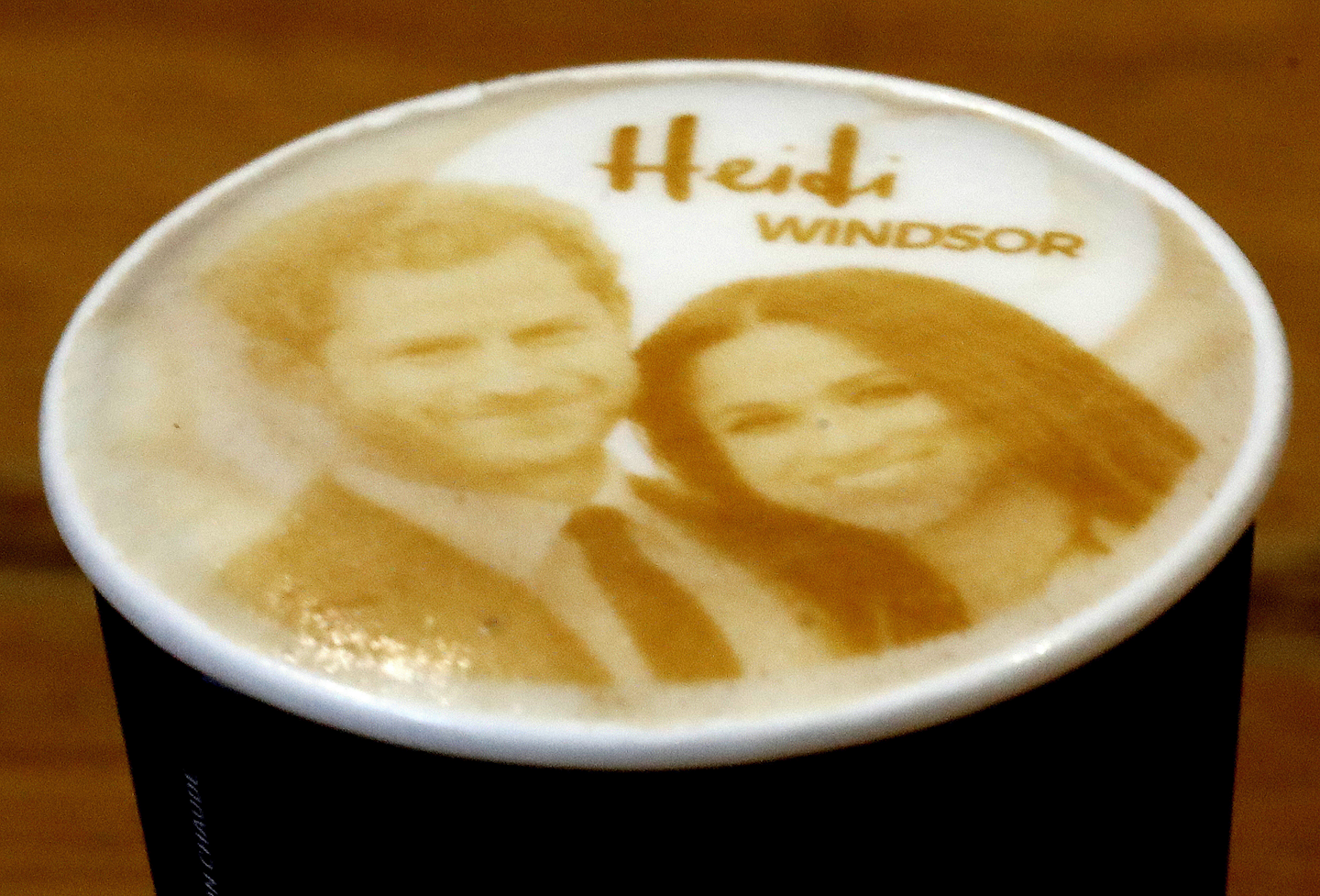 In this Tuesday, May 15, 2018 file photo capuccino coffees with the image of Britain's Prince Harry and Meghan Markle on top are pictured at a coffee shop in Windsor, England. The royal wedding smorgasbord of merchandise includes Harry and Meghan Marmite, Royal Wedding ale, Wedding Rings cereal and a limited-edition bucket of royal wedding KFC chicken. That’s just a smattering of the millions of dollars’ worth of souvenirs being sold to commemorate Prince Harry’s marriage to Meghan Markle. Estimates are that consumers will spend 40 million to 70 million pounds ($54 million to $94 million) on royal wedding-related merchandise. (AP Photo/Frank Augstein, File)