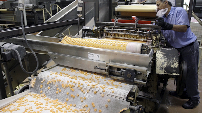 In this Jan. 14, 2009 file photo, Sweethearts candy drop onto a conveyor belt as they are manufactured at the New England Confectionery Company in Revere, Mass. Image credit: AP Photo/Charles Krupa, File