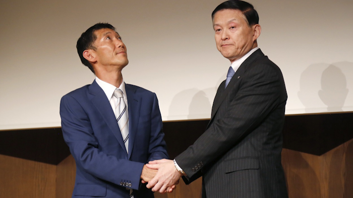 Toshiba Memory President Yasuo Naruke, right, and Bain Capital Japan chief Yuji Sugimoto, left, prepare to start their joint press conference Monday, June 4, 2018, in Tokyo. Image credit: AP Photo/Nicola Shannon