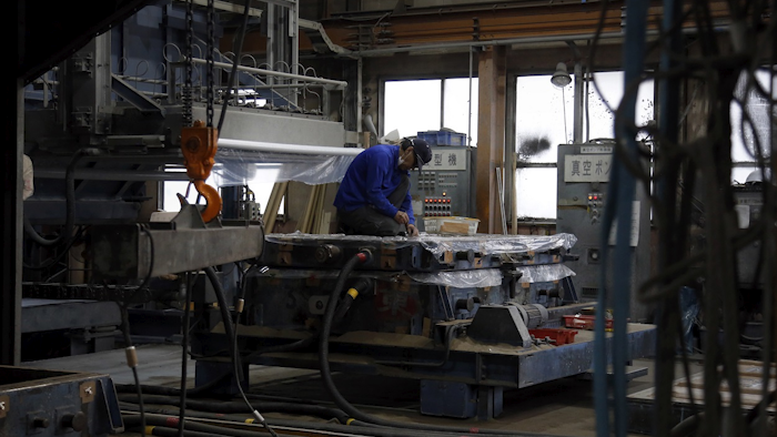 In this May 11, 2018 photo, Sakae Casting employees work in the company shop in Hachioji, in the outskirts of Tokyo. Image credit: AP Photo/Yuri Kageyama
