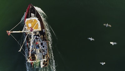 A fishing trawler makes its way through the inlet into Lake Montauk to bring its catch to one of three commercial docks in Montauk, N.Y., on Tuesday, Dec. 19, 2017. Image credit: AP Photo/Julie Jacobson