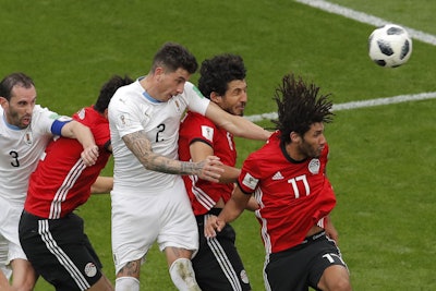 Uruguay's Jose Gimenez, center, heads the ball to score the opening goal during the group A match between Egypt and Uruguay at the 2018 soccer World Cup in the Yekaterinburg Arena in Yekaterinburg, Russia, Friday, June 15, 2018. Image credit: AP Photo/Vadim Ghirda