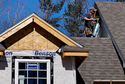 In this April 23, 2018, file photo, a worker installs vinyl siding on a new home in Auburn, N.H. Image credit: AP Photo/Charles Krupa, File