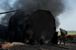 In this April 6, 2018 file photo, a former farmer works at a primitive refinery as he makes crude oil into diesel and other products, in Rmeilan, Hassakeh province, Syria. Image credit: AP Photo/Hussein Malla, file