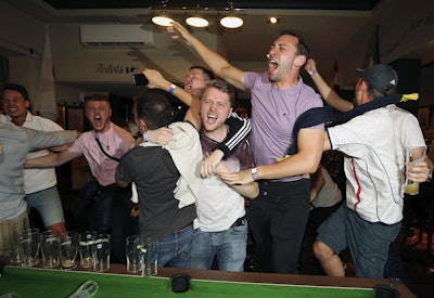 England supporters celebrate Harry Kane's winning goal as fans watch the World Cup soccer match between Tunisia and England at the Lord Raglan Pub in London, Monday, June 18, 2018. Image credit: Nigel French/PA via AP