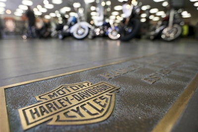 In this April 26, 2017, file photo, rows of motorcycles are behind a bronze plate with corporate information on the showroom floor at a Harley-Davidson dealership in Glenshaw, Pa. Image credit: AP Photo/Keith Srakocic, File