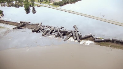 In this aerial drone image taken from video and provided by the Sioux County Sheriff's Office, tanker cars carrying crude oil are shown derailed about a mile south of Doon, Iowa, Friday, June 22, 2018. Image credit: (Sioux County Sheriff's Office via AP