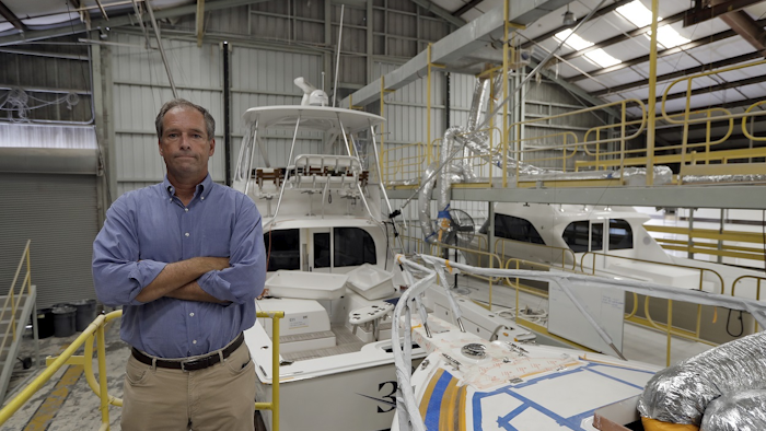 Peter Truslow, Chief Executive Officer for Bertram, a boat building company, poses near three of his custom made boats Friday, June 22, 2018, in Tampa, Fla. Image credit: AP Photo/Chris O'Meara