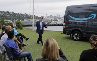 Dave Clark, senior vice president of worldwide operations for Amazon.com, talks to reporters, Wednesday, June 27, 2018, in Seattle, at a media event for Amazon to announce a new program that lets entrepreneurs around the country launch businesses that deliver Amazon packages. Image credit: AP Photo/Ted S. Warren