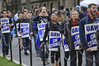 In this April 30, 2018 file photo, striking teaching assistants protest on the Columbia University campus in New York. Image credit: AP Photo/Bebeto Matthews