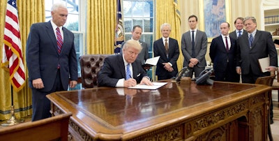 President Donald Trump signing executive orders, among those one known as the 'Mexico City Policy.' Vice President Mike Pence on the left and Chief Strategist Steve Bannon on the right. White House Chief of Staff Reince Priebus and National Trade Council Director Peter Navarro stand behind. (Donald J. Trump via Facebook)