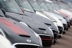 In this May 7, 2018, file photo, a long line of 2018 and 2019 Cooper Countryman and Clubman models sits at a Mini Cooper dealership in Highlands Ranch, Colo. Image credit: AP Photo/David Zalubowski, File