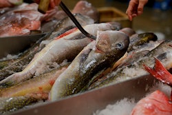 A fishmonger pulls tilefish for a buyer at the New Fulton Fish Market in New York on Monday, Jan. 8, 2018. The U.S. seafood industry is worth $17 billion a year, more than 90 percent of which is made up of imports. (AP Photo/Julie Jacobson)