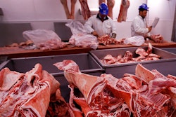 FILE - In this file photo taken on Monday, July 18, 2016, butchers prepare cuts of meat at Smithfield Market, in London. A shortage of carbon dioxide in Europe is hitting food processing companies who rely on the gas to stun animals before slaughter, as it is announced Tuesday June 26, 2018, that some meat processing plants will run out of CO2 within days. (AP Photo/Kirsty Wigglesworth, FILE)