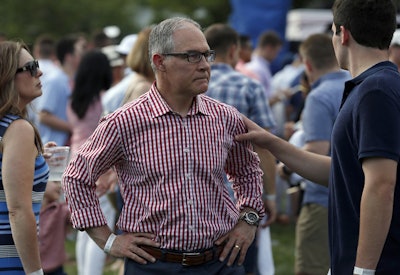 Environmental Protection Agency Administrator Scott Pruitt stands on the South Lawn during an afternoon picnic for military families at the White House, Wednesday, July 4, 2018, in Washington. Image credit: AP Photo/Alex Brandon