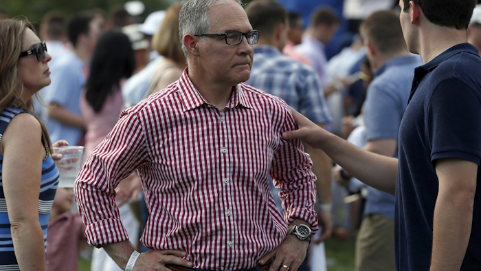 Environmental Protection Agency Administrator Scott Pruitt stands on the South Lawn during an afternoon picnic for military families at the White House, Wednesday, July 4, 2018, in Washington. Image credit: AP Photo/Alex Brandon