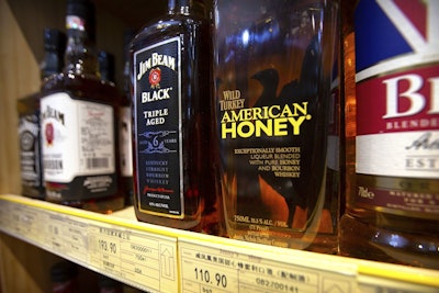 In this Saturday, July 7, 2018, file photo, whiskeys distilled and bottled in the U.S. are displayed for sale in a grocery store in Beijing. Image credit: AP Photo/Mark Schiefelbein, File