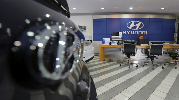 In this Jan. 25, 2018 file photo, an employee of Hyundai Motor Co. waits for customers at the company's showroom in Seoul, South Korea. Image credit: AP Photo/Ahn Young-joon, File