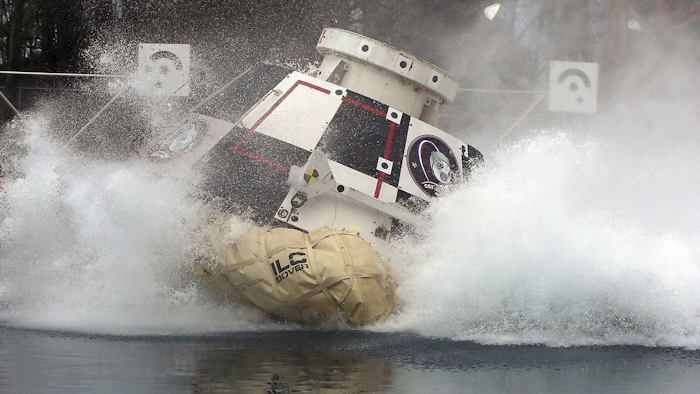 In this Feb. 9, 2016 photo made available by NASA, a mockup of Boeing’s CST-100 Starliner spacecraft, in development in partnership with NASA’s Commercial Crew Program, splashes into a 20-foot-deep basin at NASA’s Langley Research Center in Hampton, Va., during testing of the spacecraft’s landing systems design. Image credit: David C. Bowman/NASA via AP