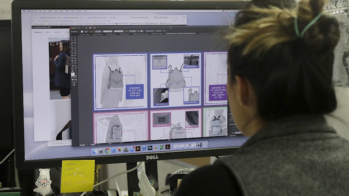 In this Feb. 15, 2018 photo, designer Tiffany Tam shows sketches of a handbag she designed on her computer at a Betabrand store in San Francisco. Image credit: AP Photo/Jeff Chiu