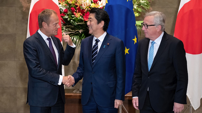 Japanese Prime Minister Shinzo Abe, center, shakes hands with European Council President Donald Tusk next to European Commission President Jean-Claude Juncker, right, before a meeting at Abe's official residence in Tokyo Tuesday, July 17, 2018. Image credit: Martin Bureau/Pool Photo via AP