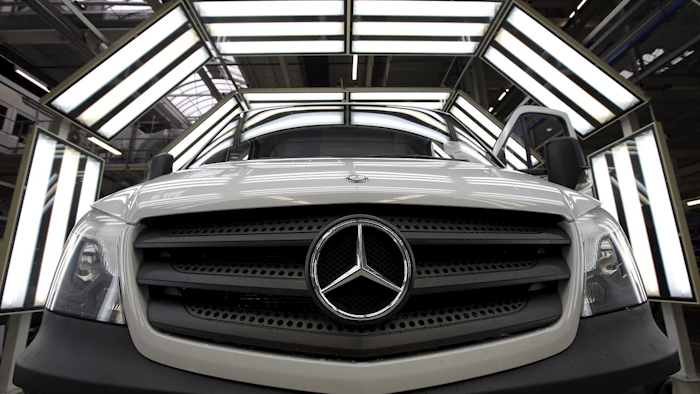 In this June 23, 2015 file photo a van is pictured in a light tunnel at the Mercedes-Benz automobile plant in Ludwigsfelde, near Berlin. Image credit: Photo/Michael Sohn, file