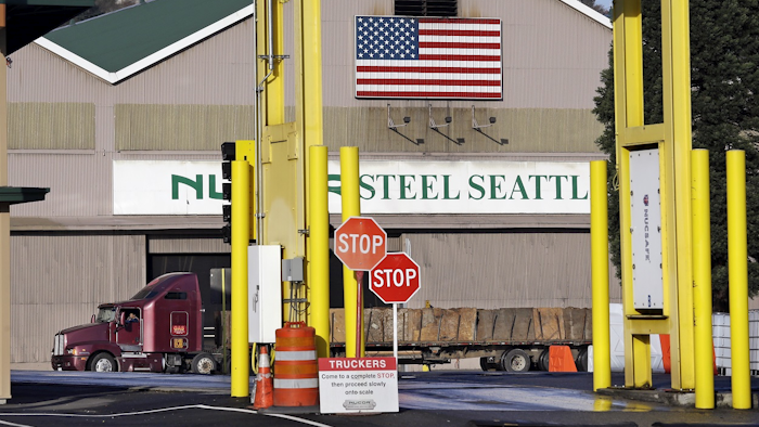 In this Feb. 25, 2016 file photo, a truck carries a load at the Nucor Steel plant in Seattle. Image credit: AP Photo/Elaine Thompson, File