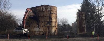 In this Dec. 11, 2017, photo, a tank at a Kiel Bros. facility is torn down in Indianapolis. The collapse of Kiel Bros. Oil Co. in 2004 was widely publicized. Less known is that the state of Indiana and, to a smaller extent, Kentucky and Illinois, are still on the hook for millions of dollars to clean up more than 85 contaminated sites across the three states, including underground tanks that leaked toxic chemicals into soil, streams and wells. (AP Photo/Brian Slodysko)